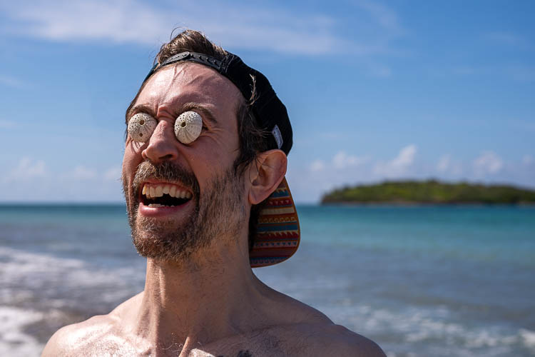 Portrait of a man at the beach with two seashells for eyes